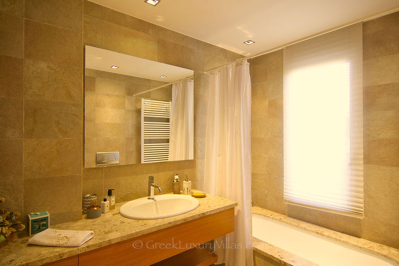 en suite bathroom of double room at luxury villa with pool