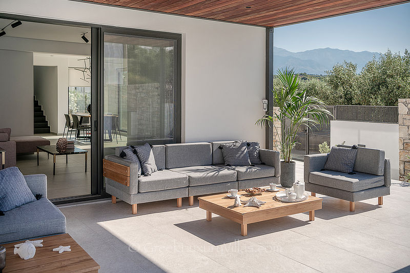 outdoor lounge of modern villa with pool by the sea