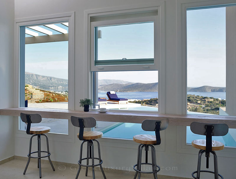 Having coffee with seaview at a luxury villa with a pool in Elounda, Crete