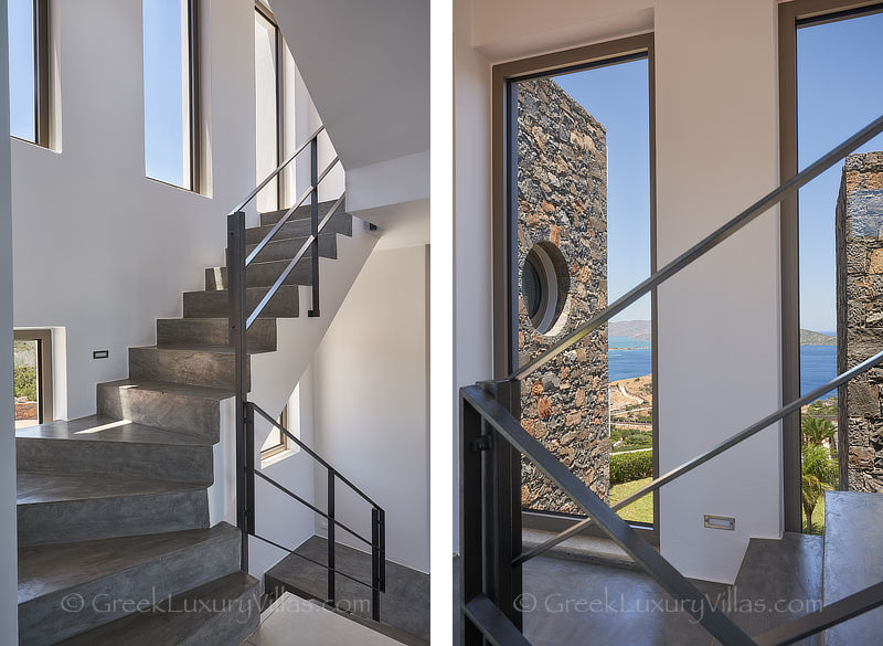 impressive staircase of modern luxury villa with heated pool overlooking elounda bay
