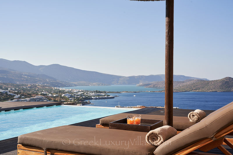 heated infinity pool overlooking elounda bay
