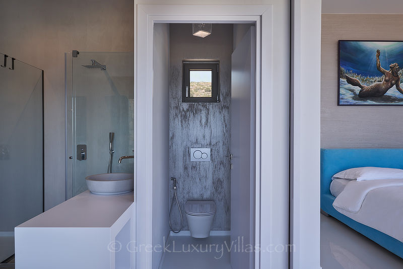 bedroom with en suite bathroom of luxury villa with pool in elounda Crete