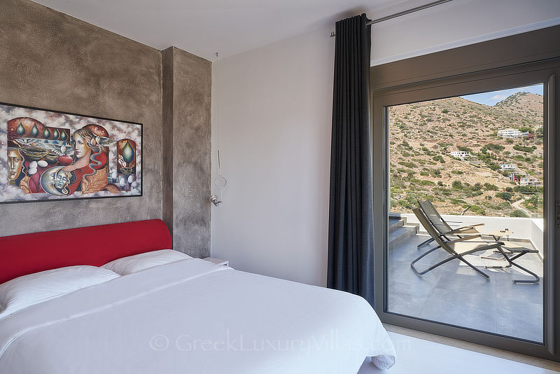 bedroom of modern luxury villa with heated pool overlooking elounda bay