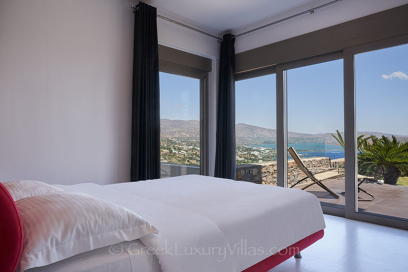 panoramic view from bedroom in modern luxury villa with heated pool in elounda