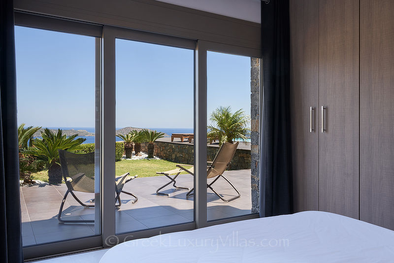 bedroom with view in luxury villa with pool overlooking elounda bay Crete