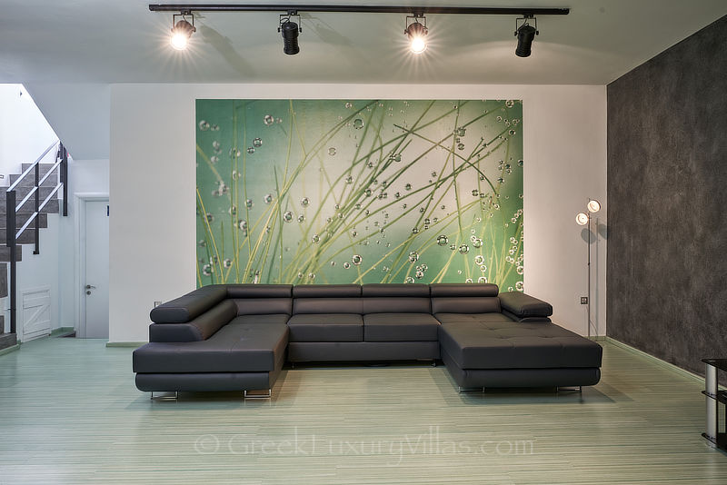 tv play room of modern luxury villa with heated pool overlooking elounda bay