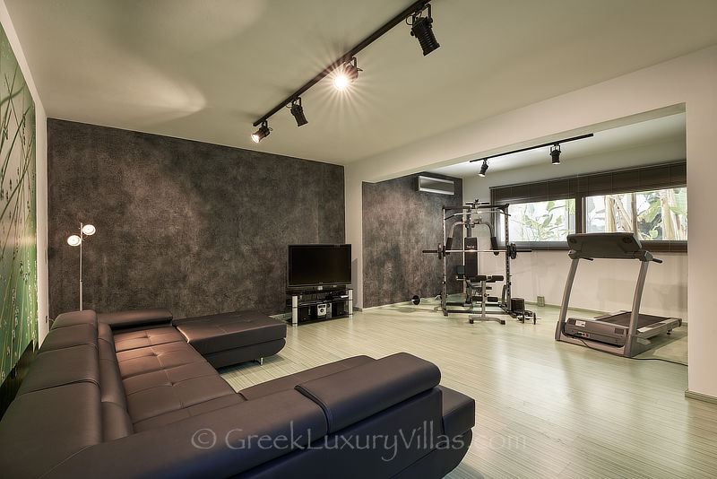gym of modern luxury villa with heated pool overlooking elounda bay Crete