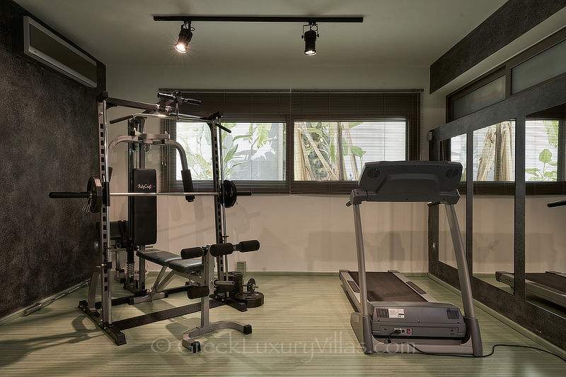 fully equipped gym of modern luxury villa with heated pool overlooking elounda bay