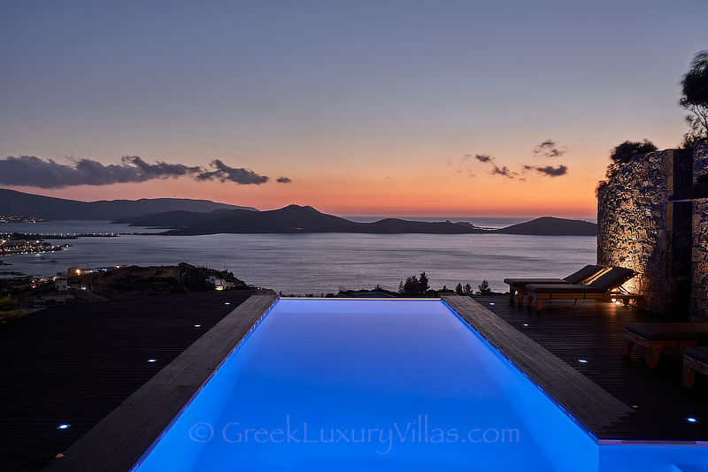 view of the sunset over elounda bay from luxury villa