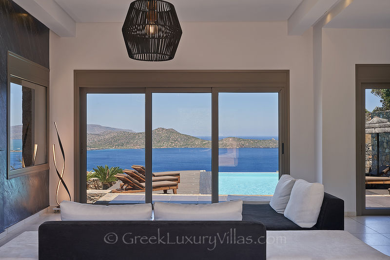modern living room of luxury villa with pool in elounda bay