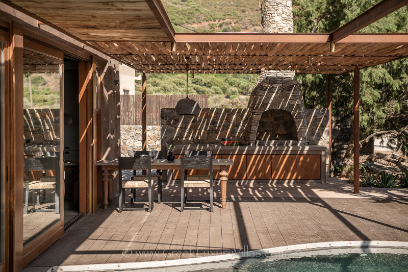 stone-built barbecue on terrace with sea view and pool in nature style