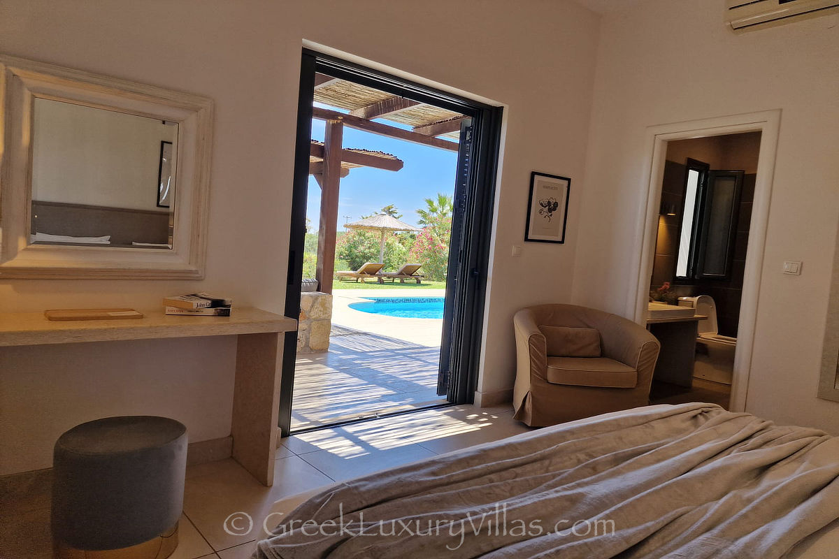 ground floor bedroom of villa with pool by the beach