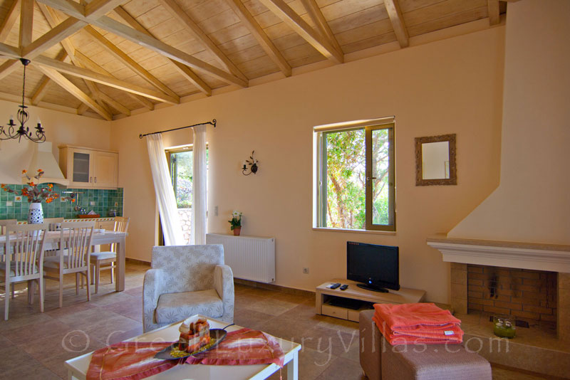 Open-plan living-room in villa with pool