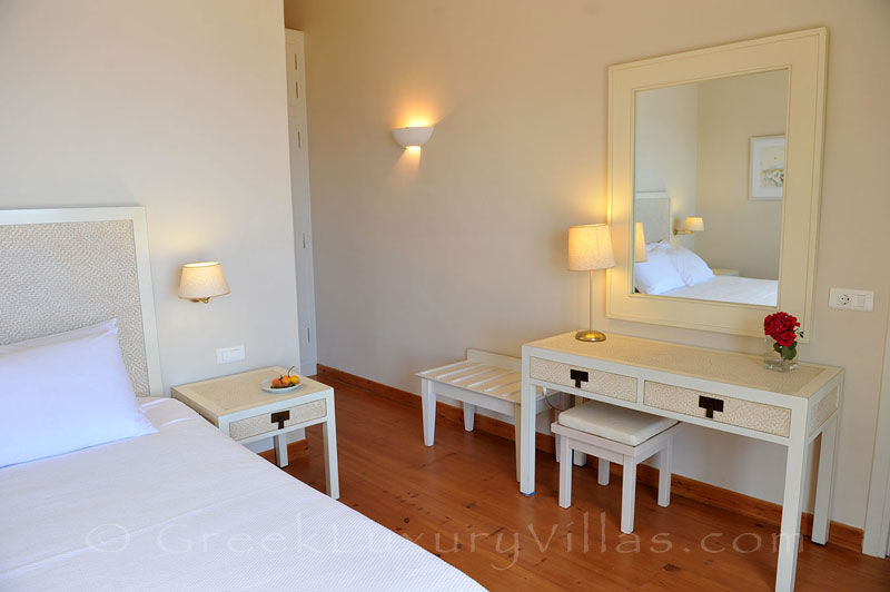 A bedroom of a luxurious villa with a pool and seaview in Lefkas