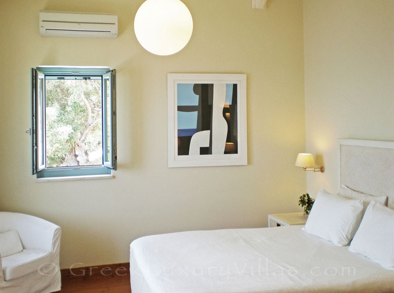A bedroom with seaview in a villa with view of the sea and a pool in Lefkas