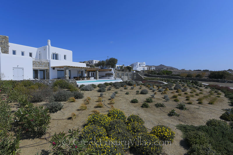 Gardens of villa with pool above Agios Stefanos Beach