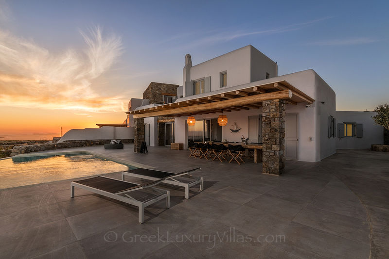 Sunset at villa with pool above Agios Stefanos Beach Mykonos
