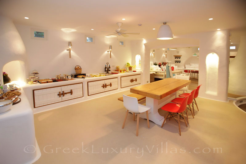 A professional kitchen and dining area in a luxury villa with a pool in Naxos
