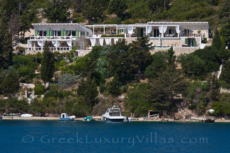 A waterfront luxury villa with a boat mooring in Paxos