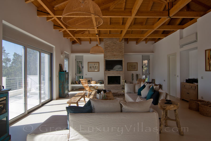 A living-room in a modern luxury villa with a pool and seaview in Paxos