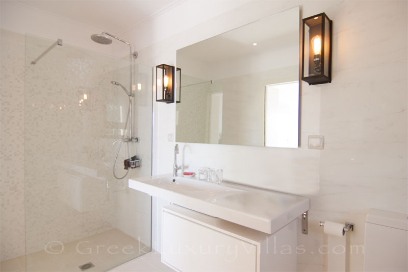 The bathroom of a modern luxury villa with a pool in Paxos