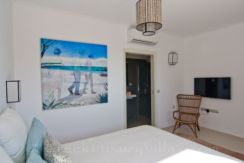 A bedroom in the guesthouse of a modern luxury villa with a pool in Paxos