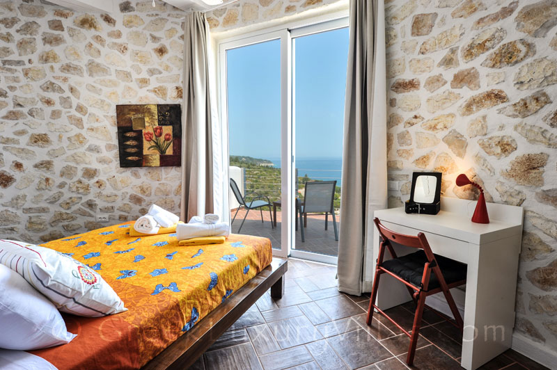 The bedroom of a villa with a pool and seaview in Paxos