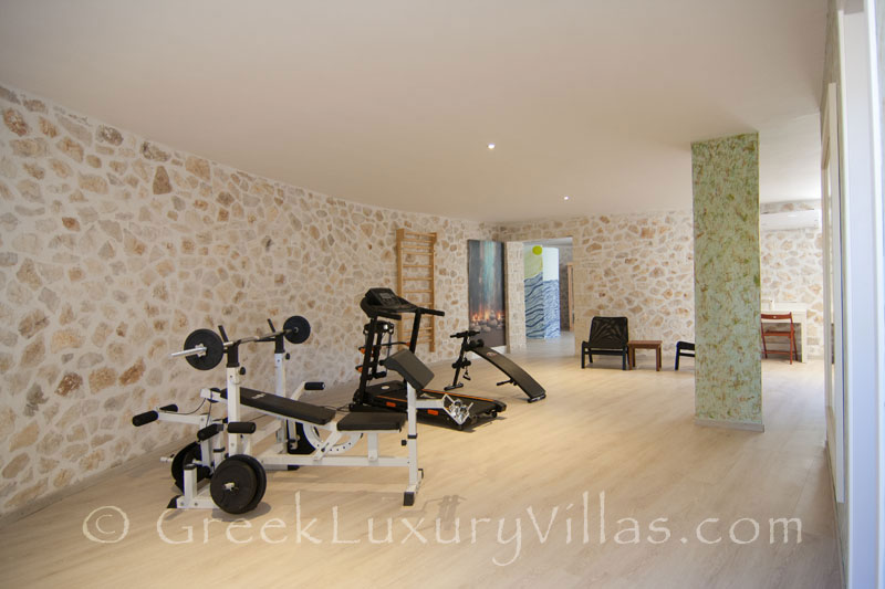 The gym and sauna of a luxury villa with a pool in Paxos