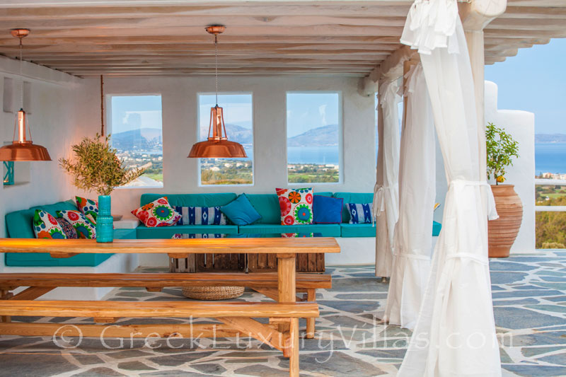 Outdoor dining area in a luxury villa with a pool in Rhodos