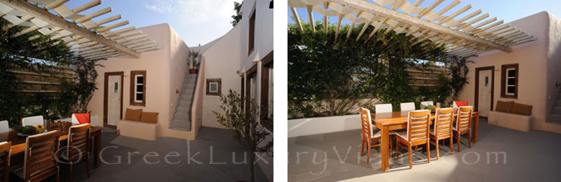 A luxury villa in Imerovigli, Santorini, with an outdoor dining area with privacy