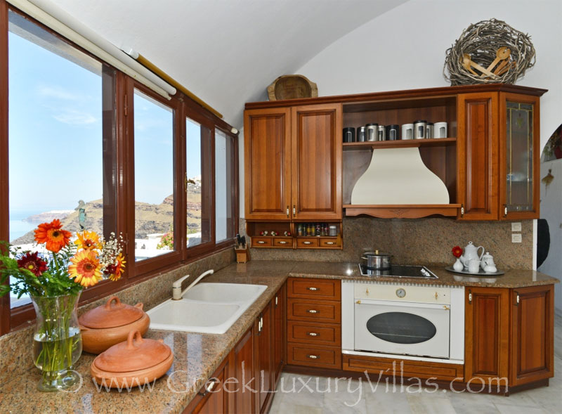 The kitchen of a large villa with a pool on the cliff of Santorini